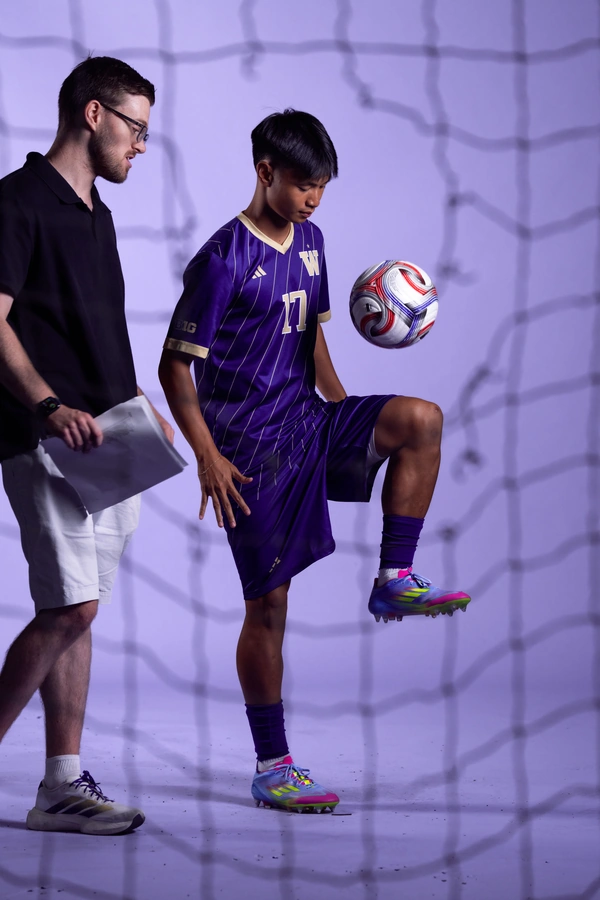 Adam Bender directing a studio shoot with a Washington soccer player