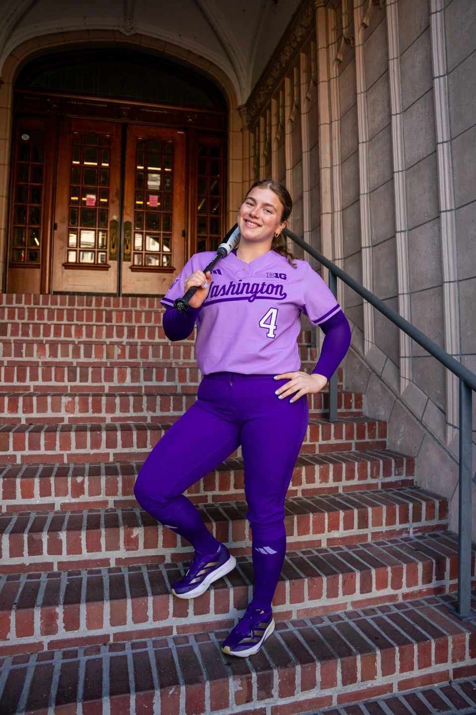 Jadyn Glab posing in the purple uniform on a brick staircase
