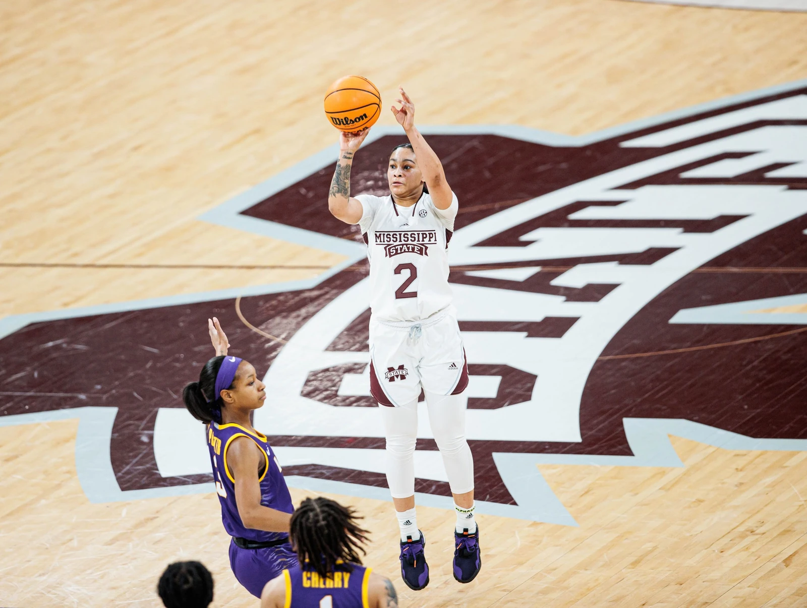 Mississippi State guard rising for a jump shot over an LSU defender