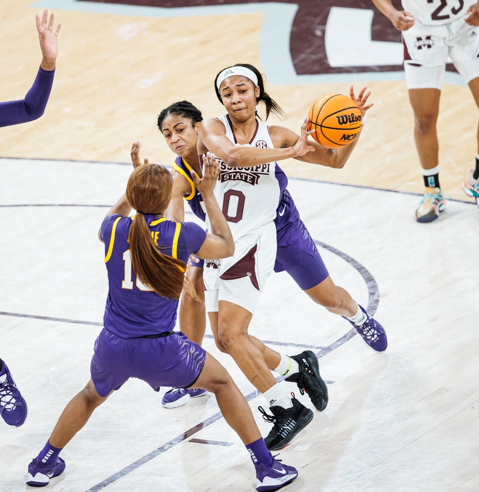 Mississippi State player driving through defenders