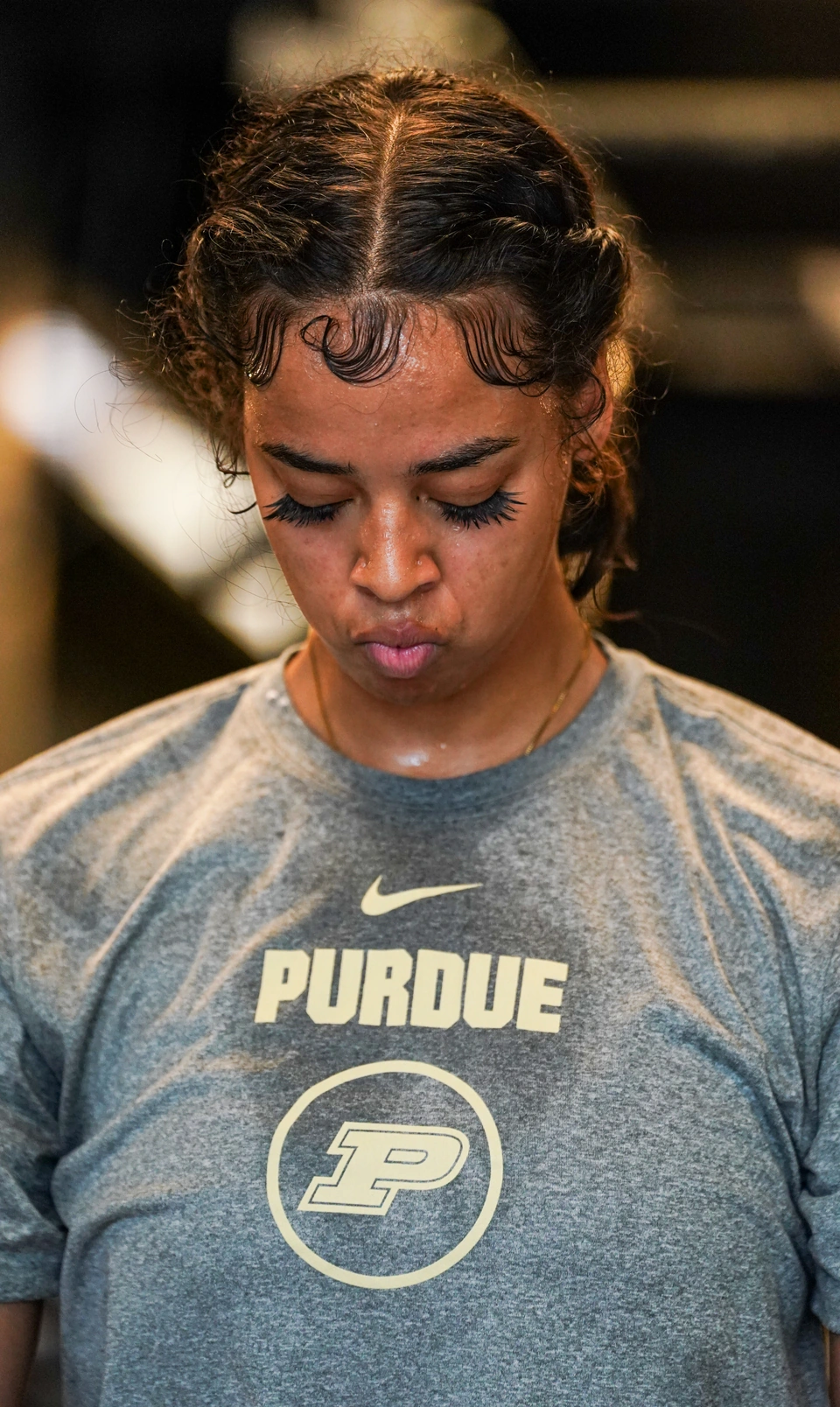 Purdue player in a warmup shirt, head down