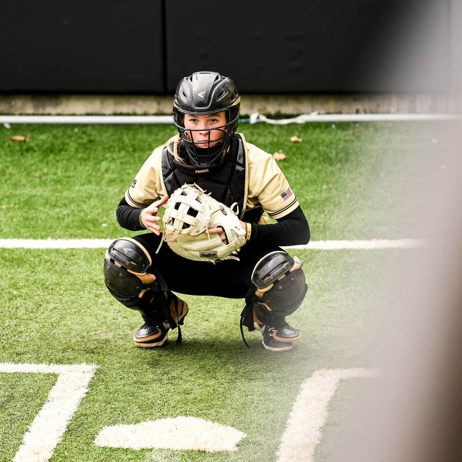 Purdue catcher crouched in the bullpen