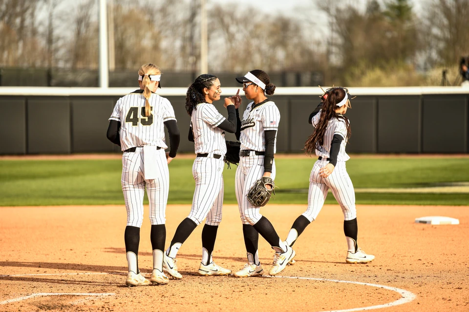 Purdue players celebrating together in the infield