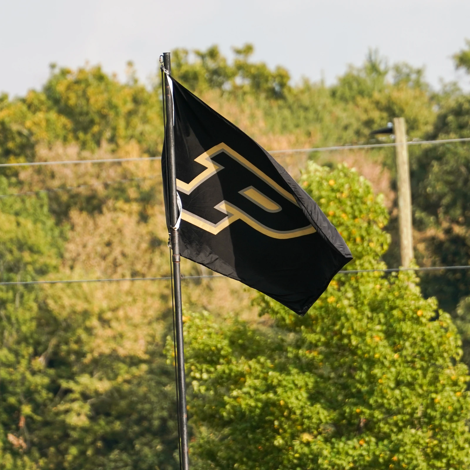 Purdue flag flying above the soccer field