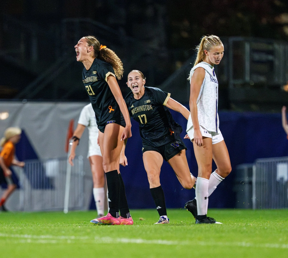 Washington women’s soccer players celebrating a goal