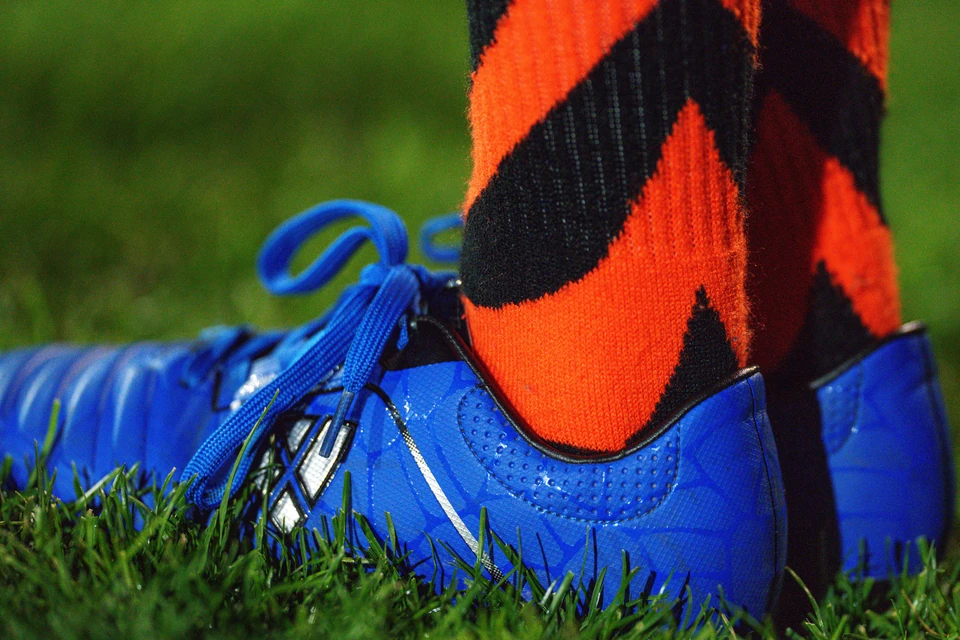 Close up of a ball kid’s cleats and socks
