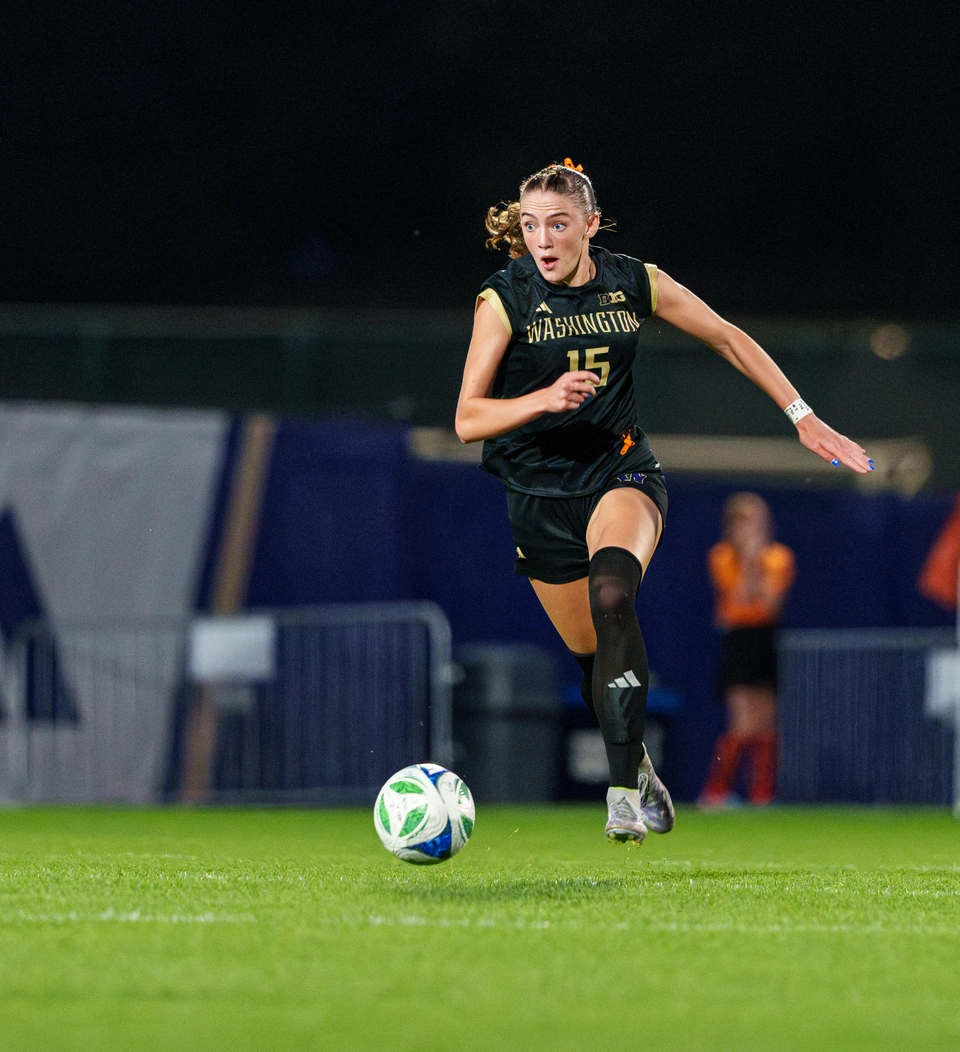 Washington player dribbling under the lights