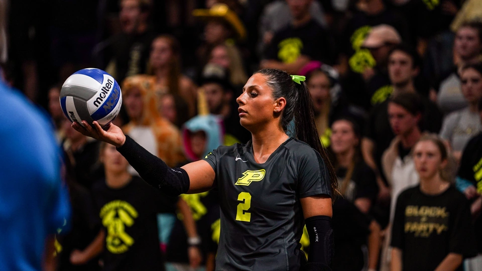 Purdue player holding the ball before serving