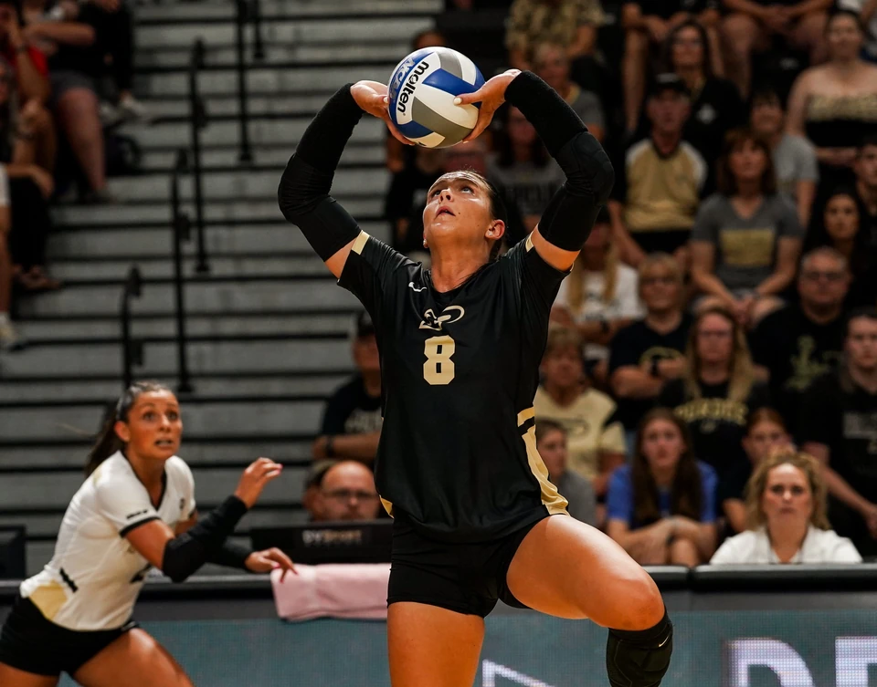 Purdue setter jump-setting the ball
